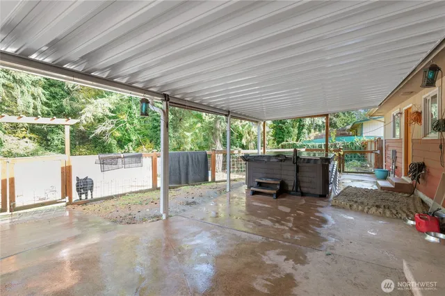 a view of a house with backyard and sitting area