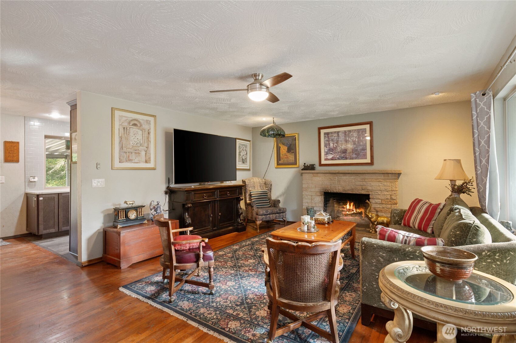 9101 112th Street Southwest Lakewood, WA 98498 - Photo 3 of 24 a living room with furniture a flat screen tv and a fireplace
