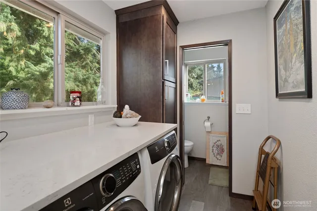 a room with a sink cabinets and a window