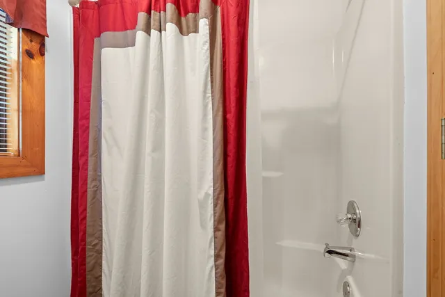 a bedroom with bed and a chandelier