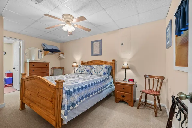 a bedroom with a bed and ceiling fan