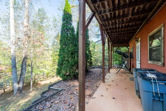 a view of a patio with a table and chairs and wooden floor