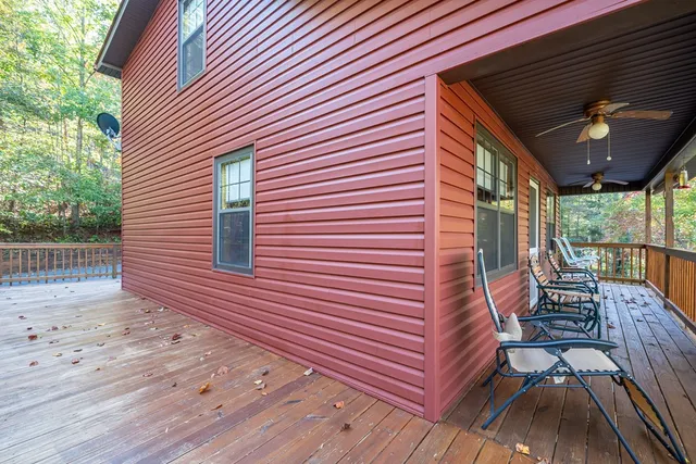 a view of a lush green forest with mountains in the background