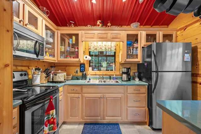 a kitchen with stainless steel appliances granite countertop a refrigerator a stove and a sink