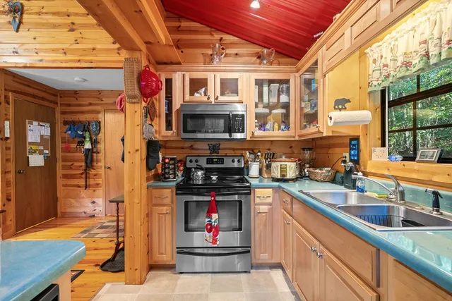 a kitchen with stainless steel appliances granite countertop a stove and a sink