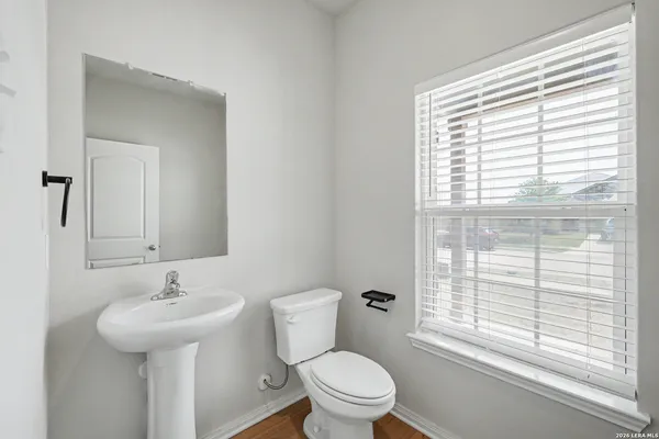 a bathroom with a toilet a sink and a window