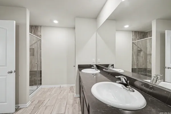a bathroom with a sink double vanity and a mirror