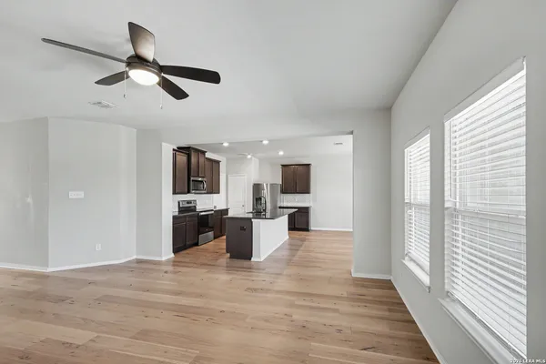 a view of a living room with wooden floor and a window