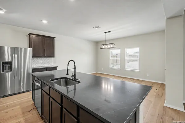 a kitchen with kitchen island a sink appliances and a counter top space