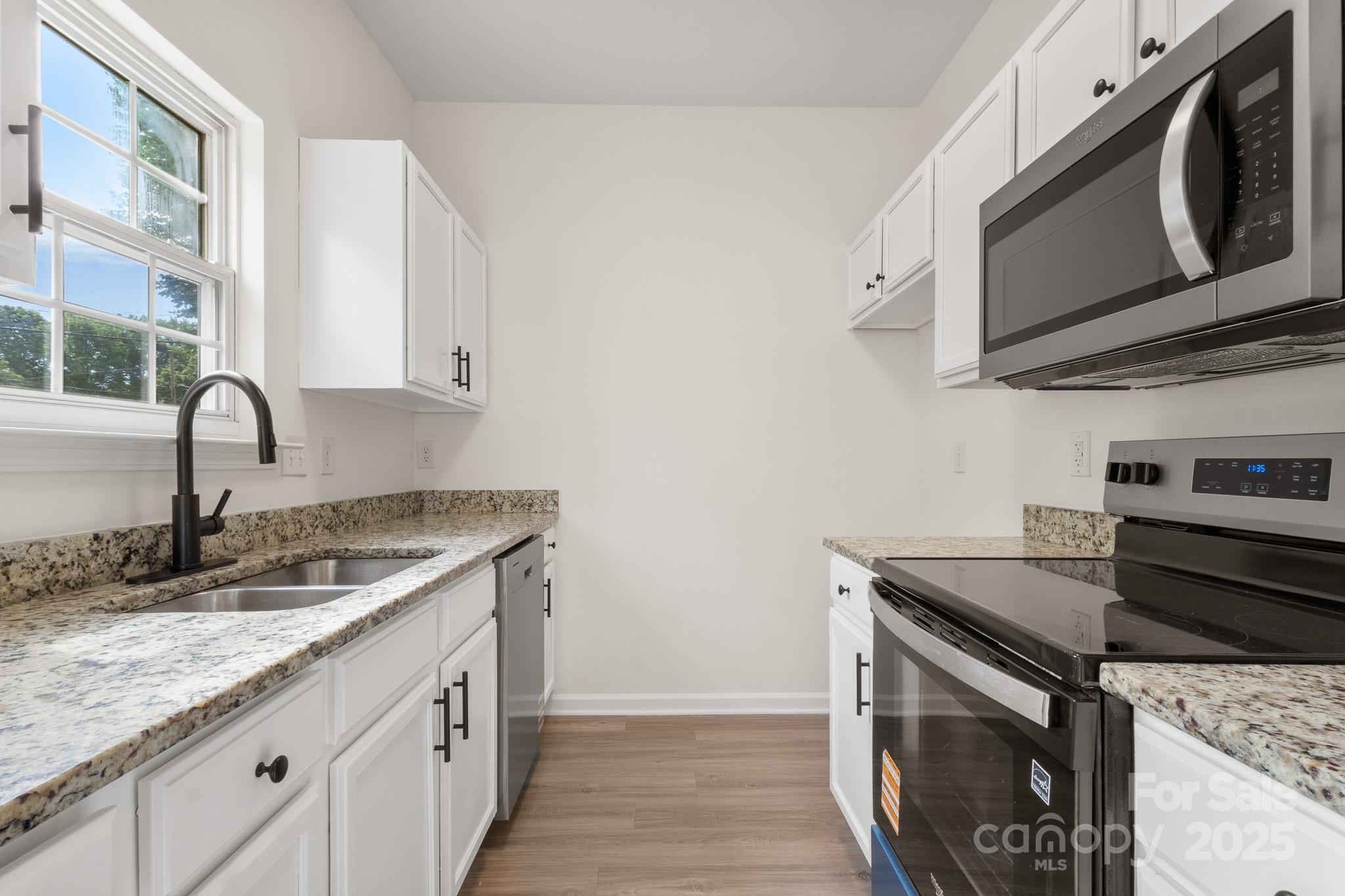 5529 Seths Drive Charlotte, NC 28269 - Photo 13 of 32 a kitchen with stainless steel appliances granite countertop a sink and a stove