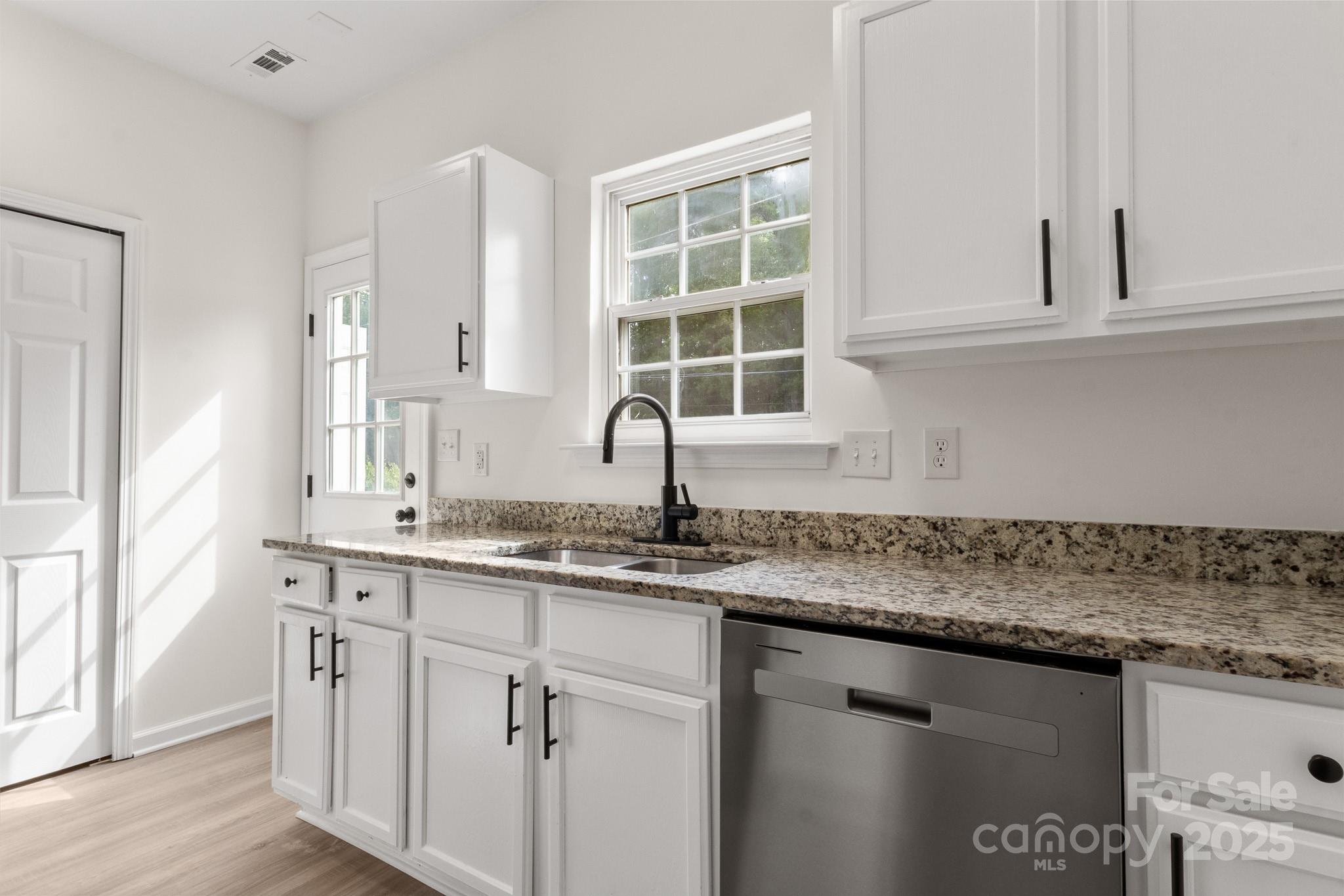 5529 Seths Drive Charlotte, NC 28269 - Photo 14 of 32 a kitchen with stainless steel appliances granite countertop a sink and a window