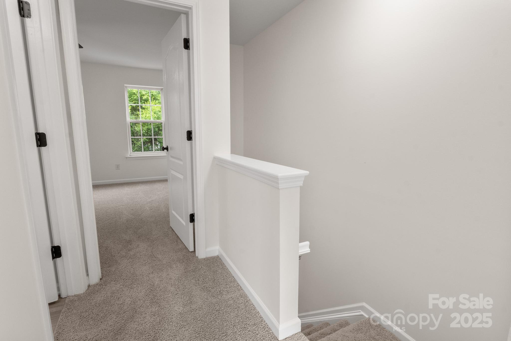 5529 Seths Drive Charlotte, NC 28269 - Photo 17 of 32 a view of a hallway with wooden floor