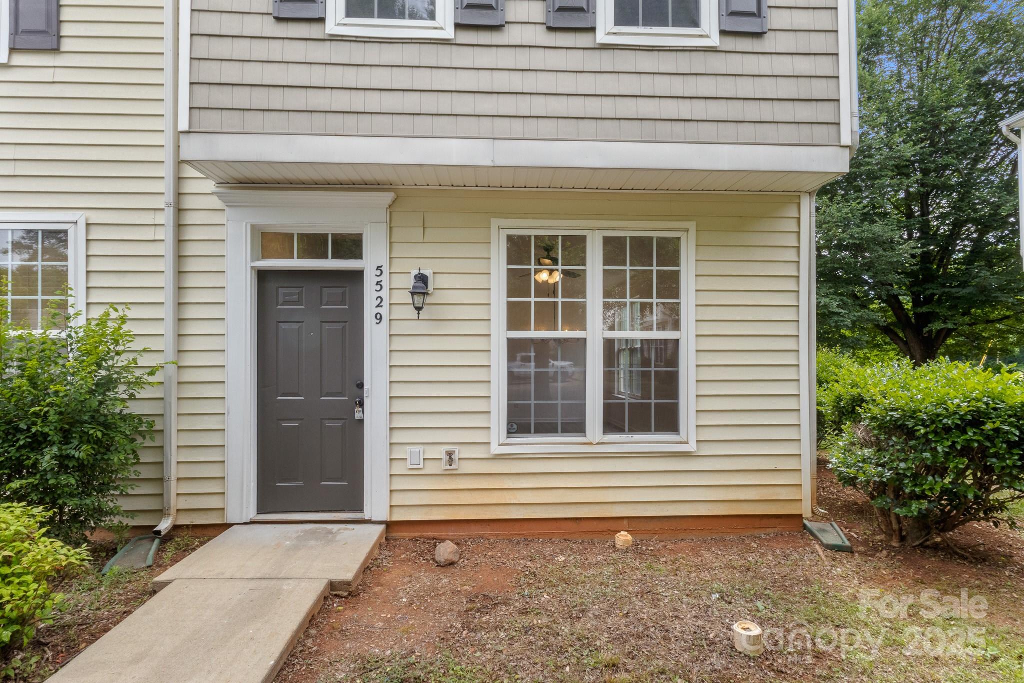 5529 Seths Drive Charlotte, NC 28269 - Photo 2 of 32 a view of a house with a window and flower plants