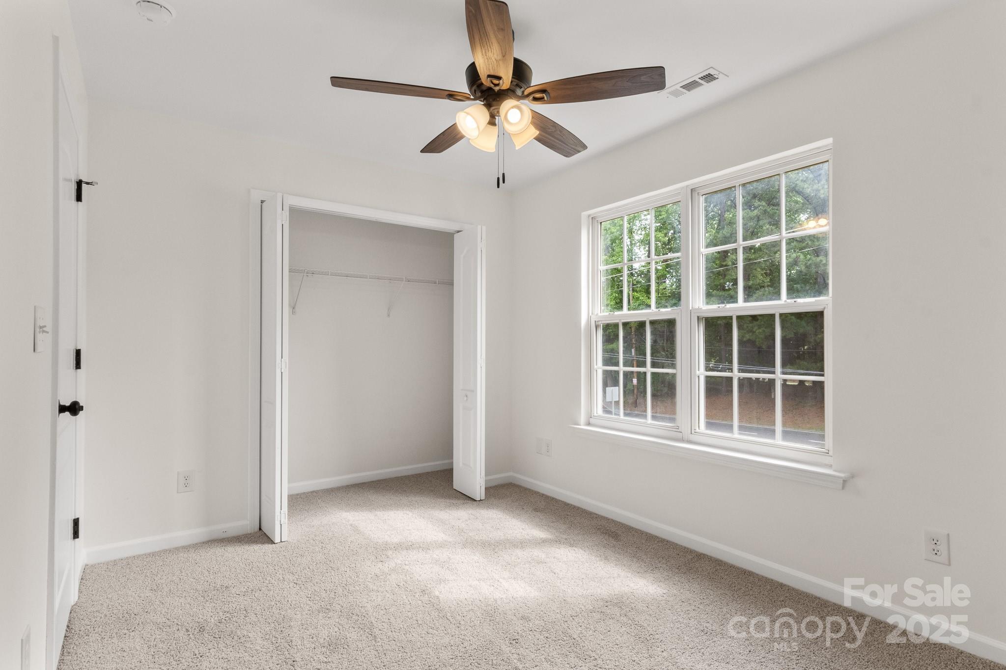 5529 Seths Drive Charlotte, NC 28269 - Photo 28 of 32 an empty room with windows and fan