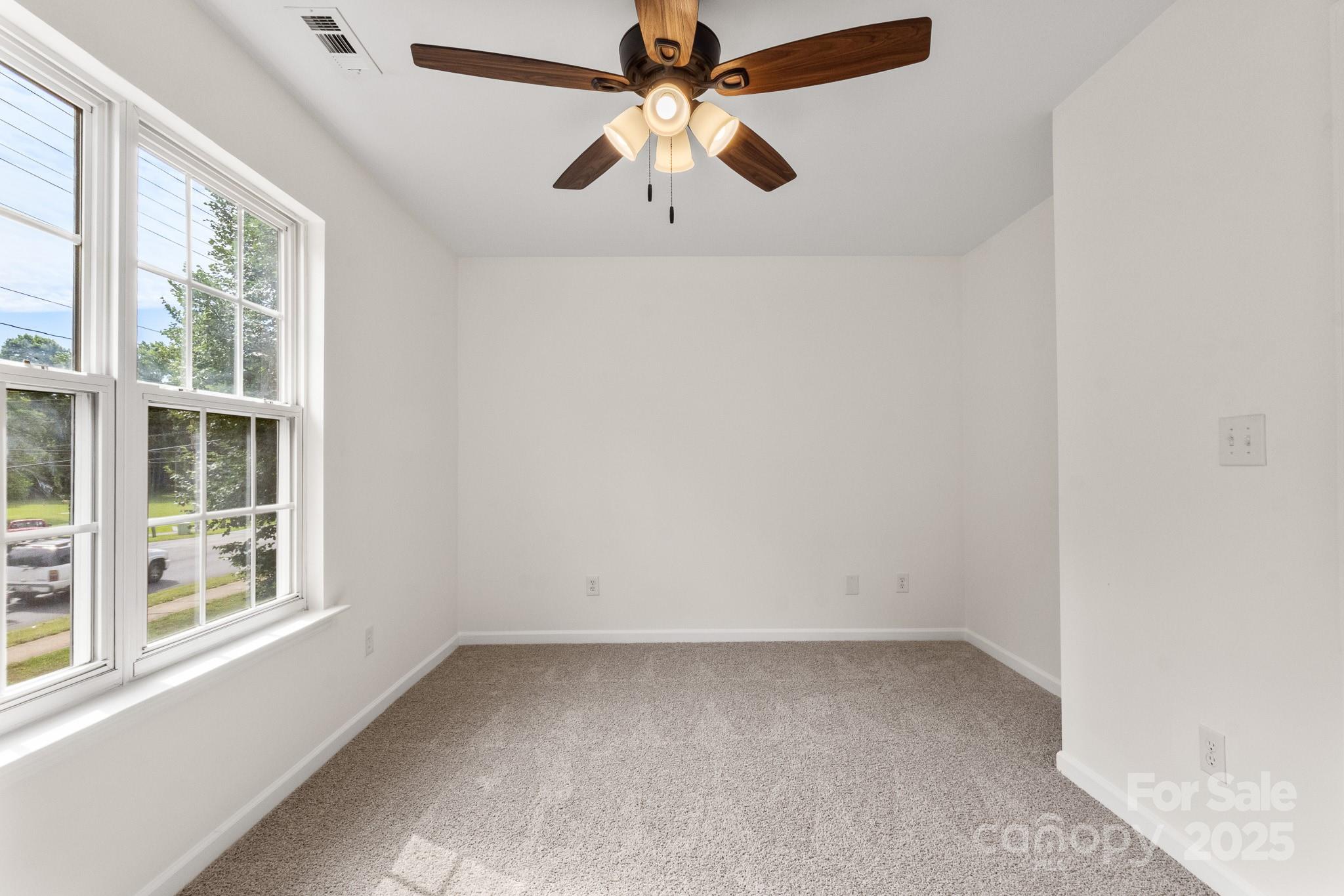 5529 Seths Drive Charlotte, NC 28269 - Photo 30 of 32 an empty room with windows and fan
