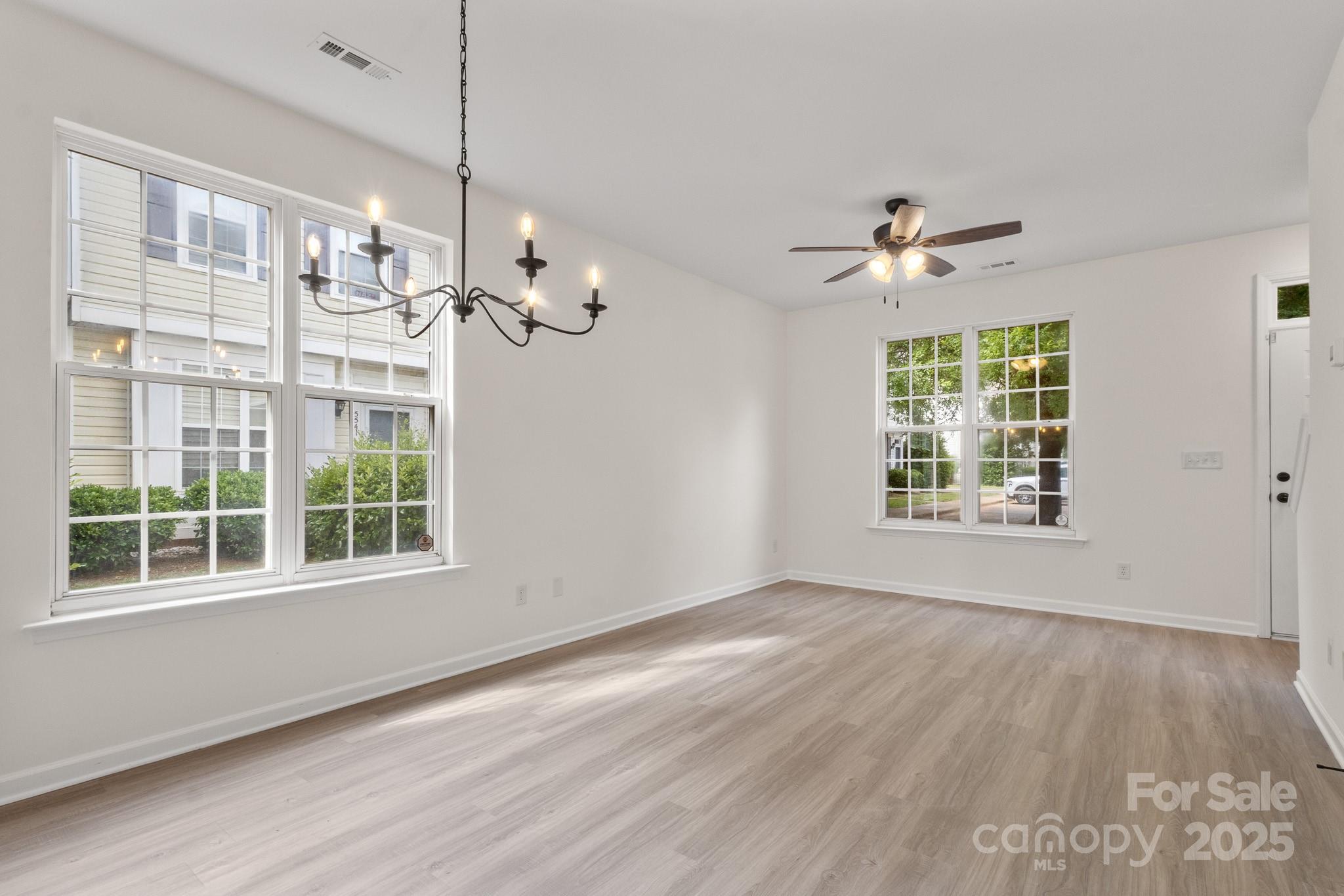5529 Seths Drive Charlotte, NC 28269 - Photo 7 of 32 a view of an empty room with wooden floor and a window