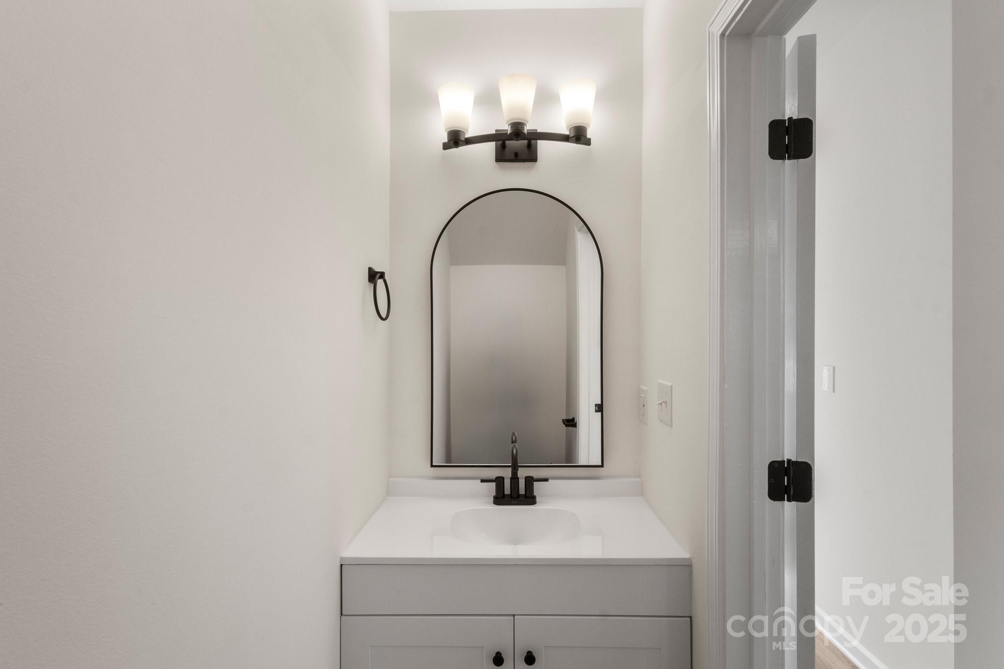 5529 Seths Drive Charlotte, NC 28269 - Photo 9 of 32 a bathroom with a sink and a mirror