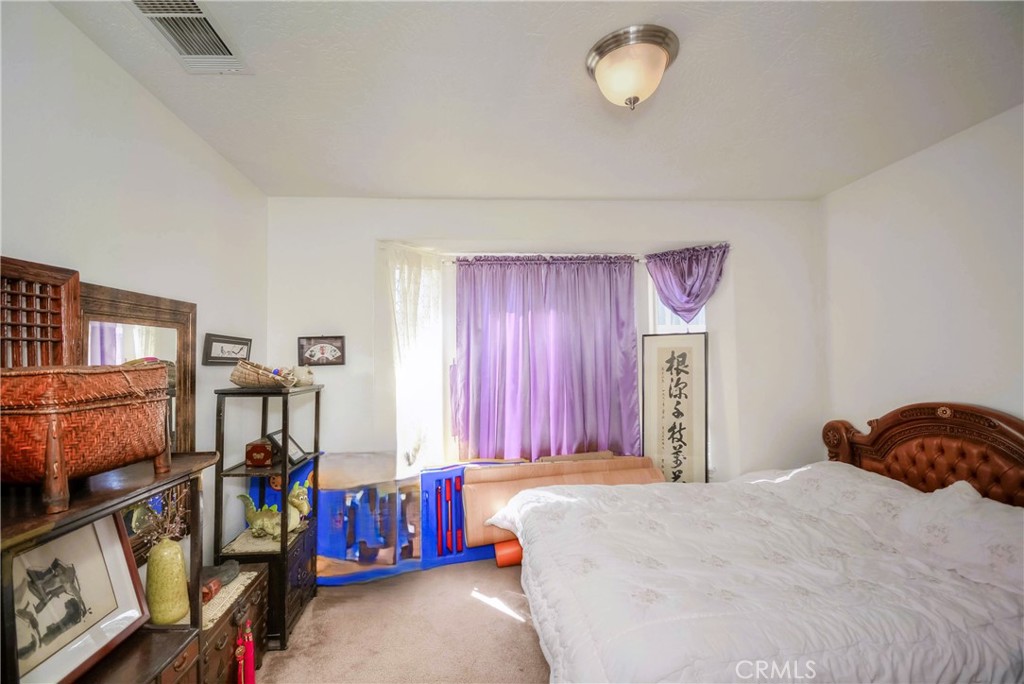 9331 Manada Road Phelan, CA 92371 - Photo 21 of 38 a bedroom with a bed and a window