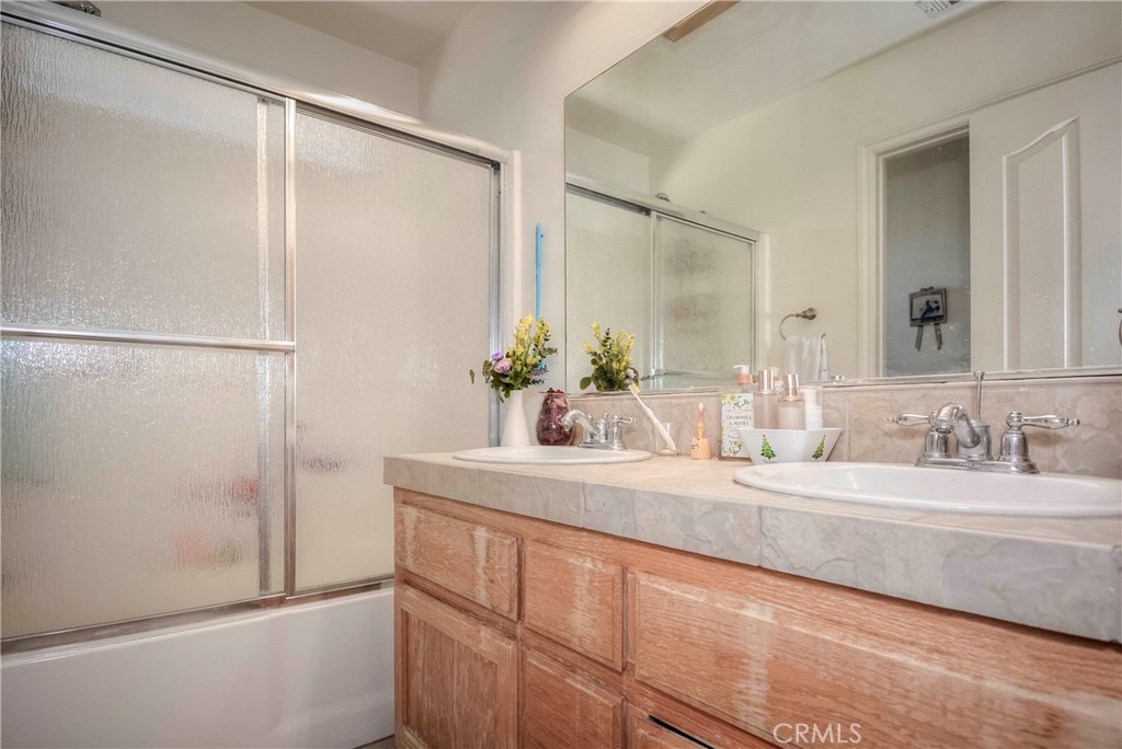 9331 Manada Road Phelan, CA 92371 - Photo 22 of 38 a bathroom with a double vanity sink and a mirror