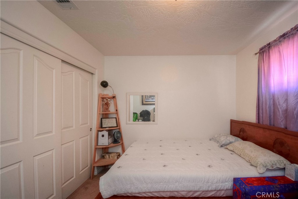 9331 Manada Road Phelan, CA 92371 - Photo 24 of 38 a bedroom with a bed and a closet