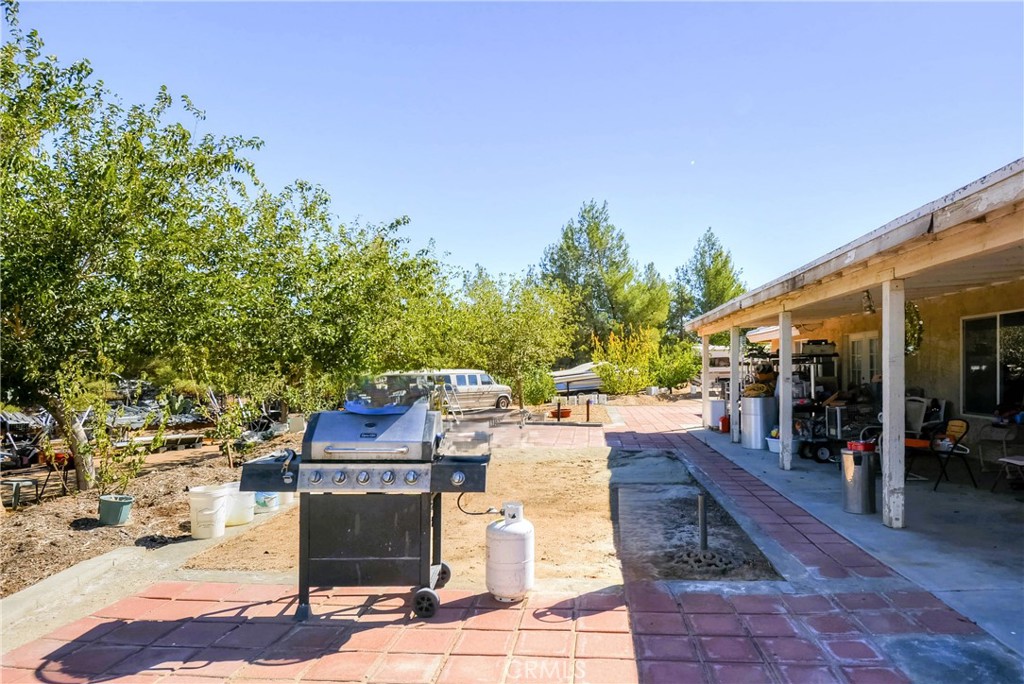 9331 Manada Road Phelan, CA 92371 - Photo 26 of 38 a view of a patio with table and chairs and potted plants