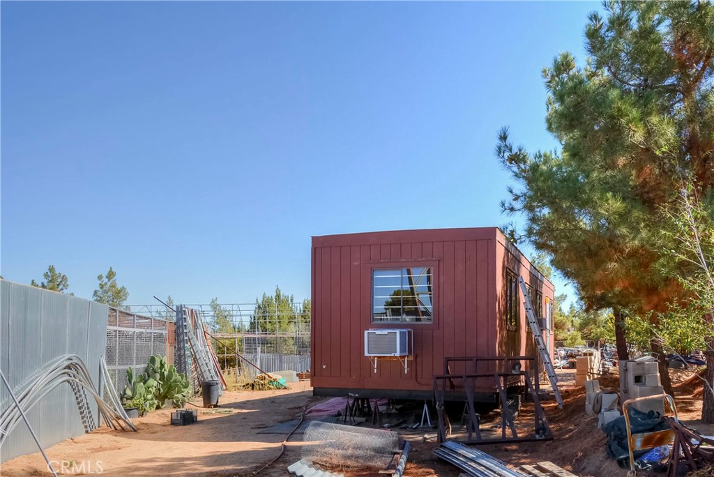 9331 Manada Road Phelan, CA 92371 - Photo 30 of 38 a front view of a building with tree s