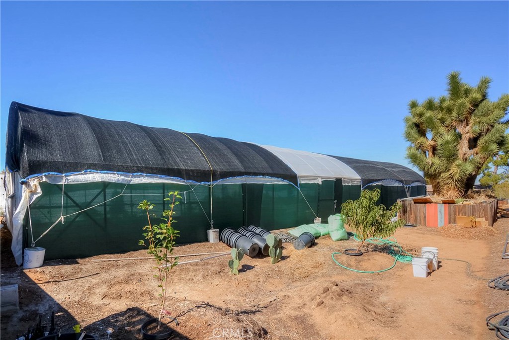 9331 Manada Road Phelan, CA 92371 - Photo 32 of 38 a view of a backyard with a sitting area