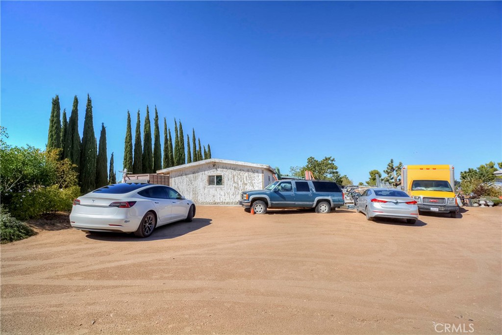 9331 Manada Road Phelan, CA 92371 - Photo 6 of 38 a car parked in front of a house with cars parked