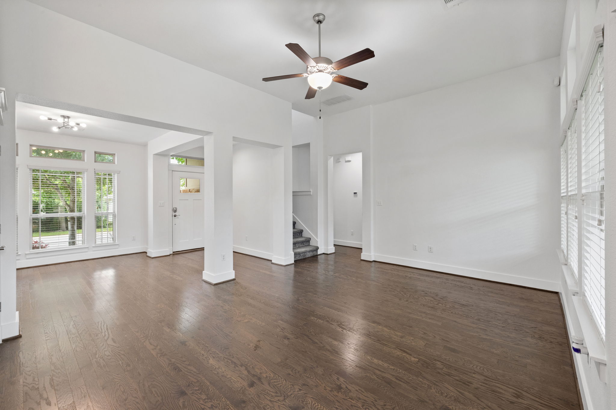 1765 Rowdy Loop, Unit 47 Leander, TX 78641 - Photo 13 of 39 Open-concept living space featuring high vaulted ceilings, rich wood-finish flooring, and crisp white walls