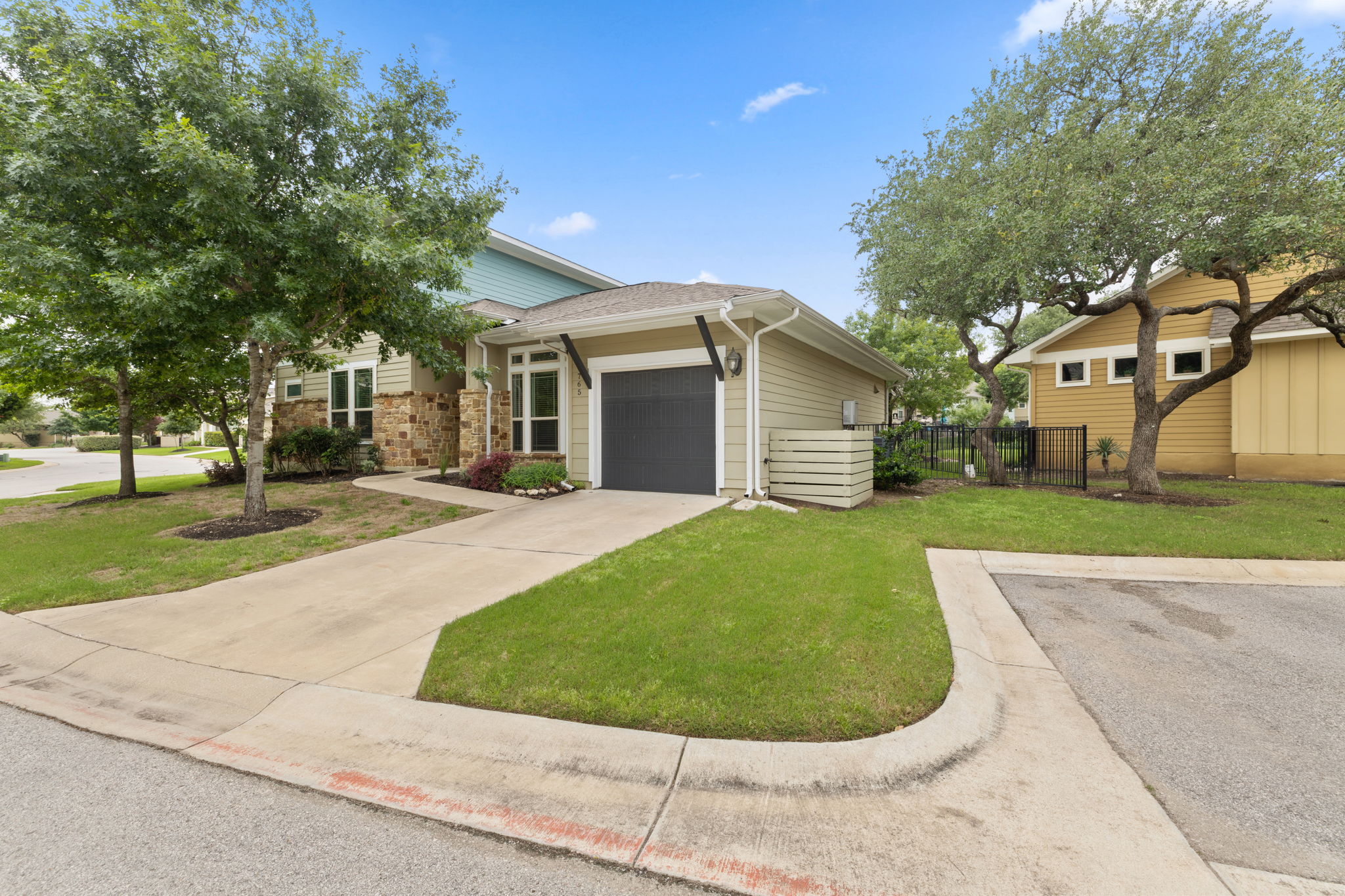 1765 Rowdy Loop, Unit 47 Leander, TX 78641 - Photo 2 of 39 Contemporary single-story residence with a stone and siding exterior