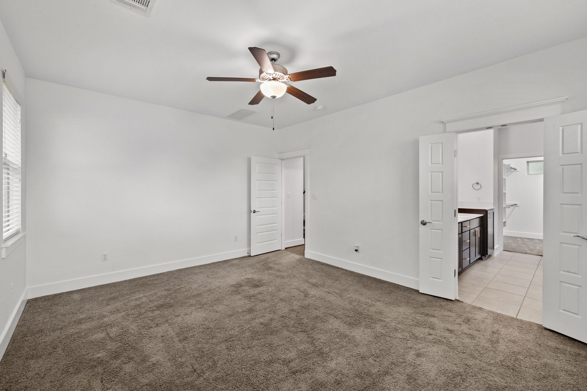 1765 Rowdy Loop, Unit 47 Leander, TX 78641 - Photo 27 of 39 Spacious room featuring neutral carpet flooring and a ceiling fan with light fixture