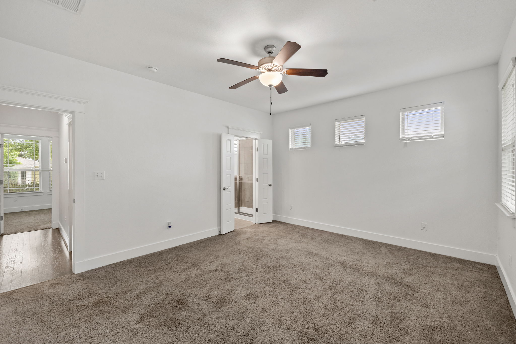 1765 Rowdy Loop, Unit 47 Leander, TX 78641 - Photo 28 of 39 Spacious room with plush carpet flooring, white walls, and bright white trim