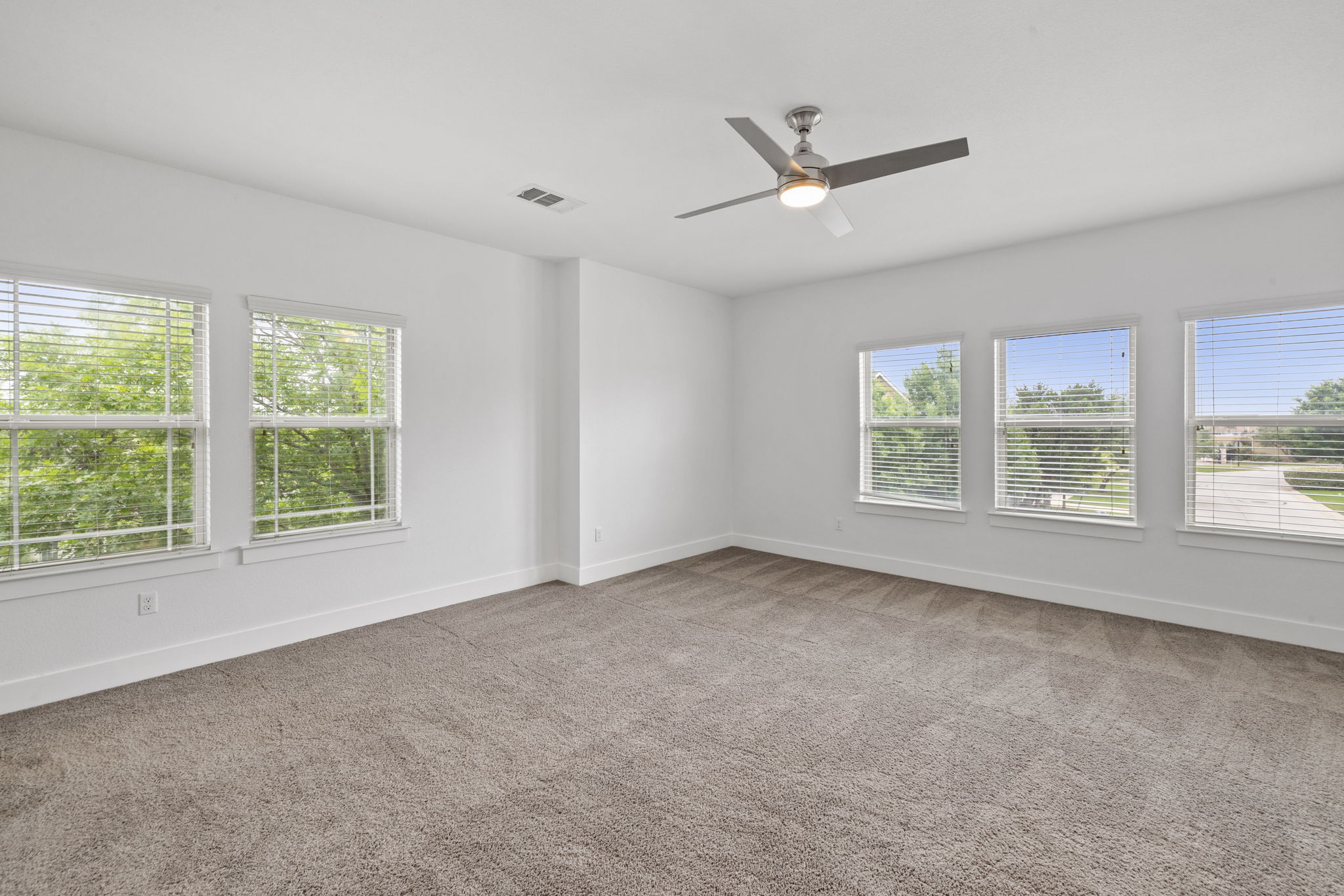 1765 Rowdy Loop, Unit 47 Leander, TX 78641 - Photo 33 of 39 Spacious room with plush gray carpeting, white walls, and bright white trim