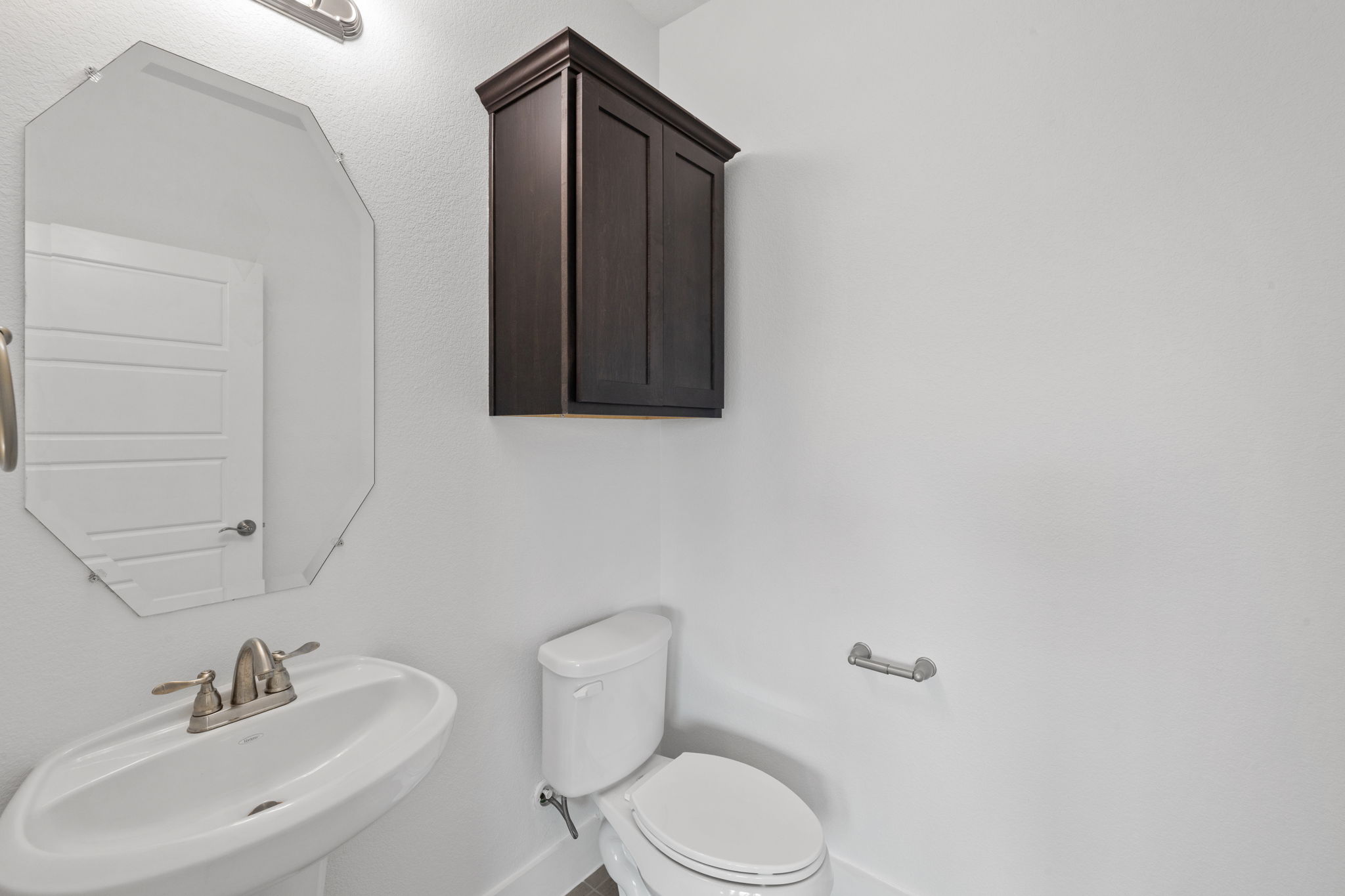 1765 Rowdy Loop, Unit 47 Leander, TX 78641 - Photo 36 of 39 Pedestal sink with brushed nickel faucet, octagonal frameless mirror, and overhead vanity lighting