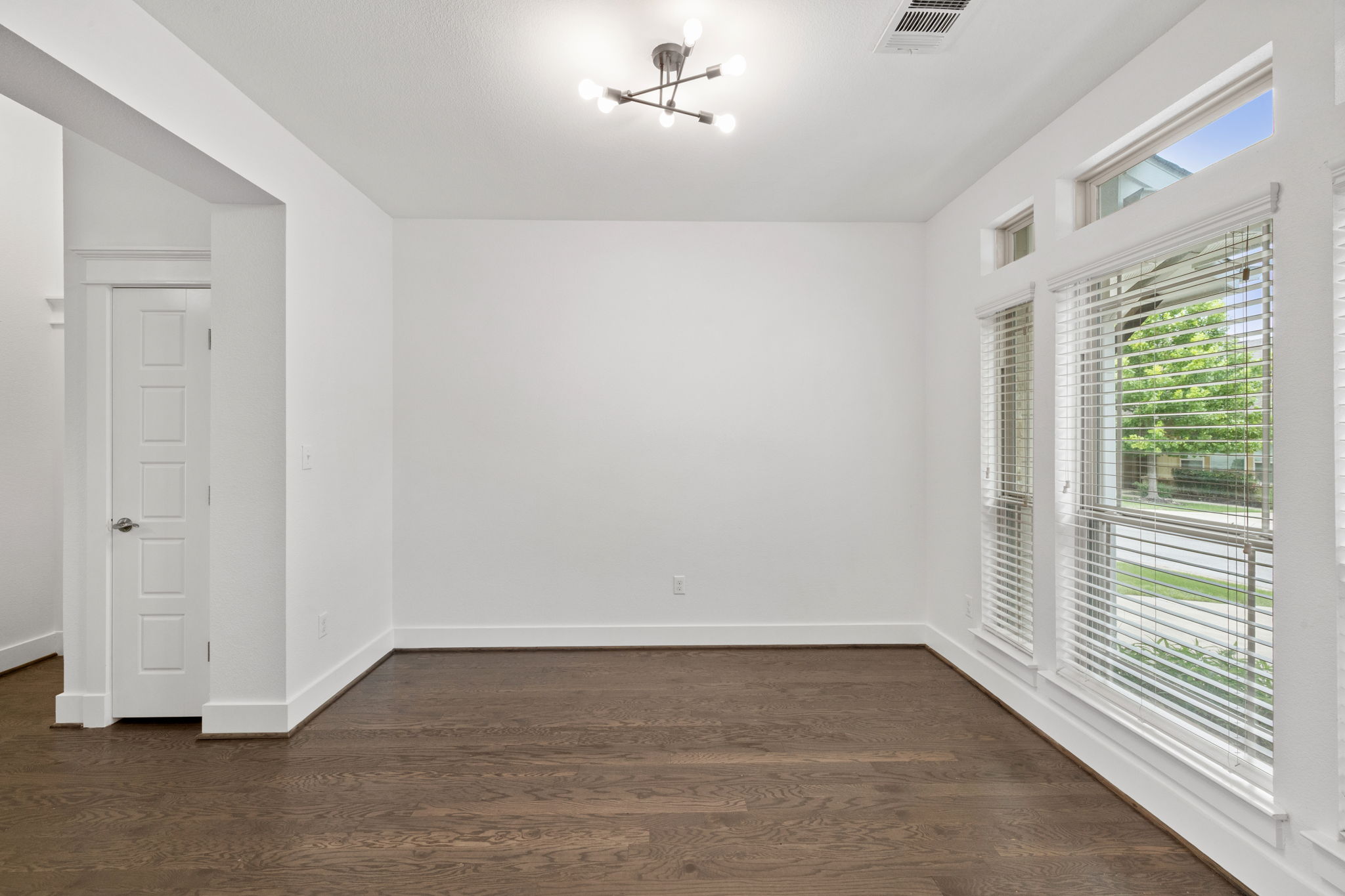 1765 Rowdy Loop, Unit 47 Leander, TX 78641 - Photo 6 of 39 Bright interior space featuring wood-finish flooring, white baseboards, and a contemporary ceiling light fixture
