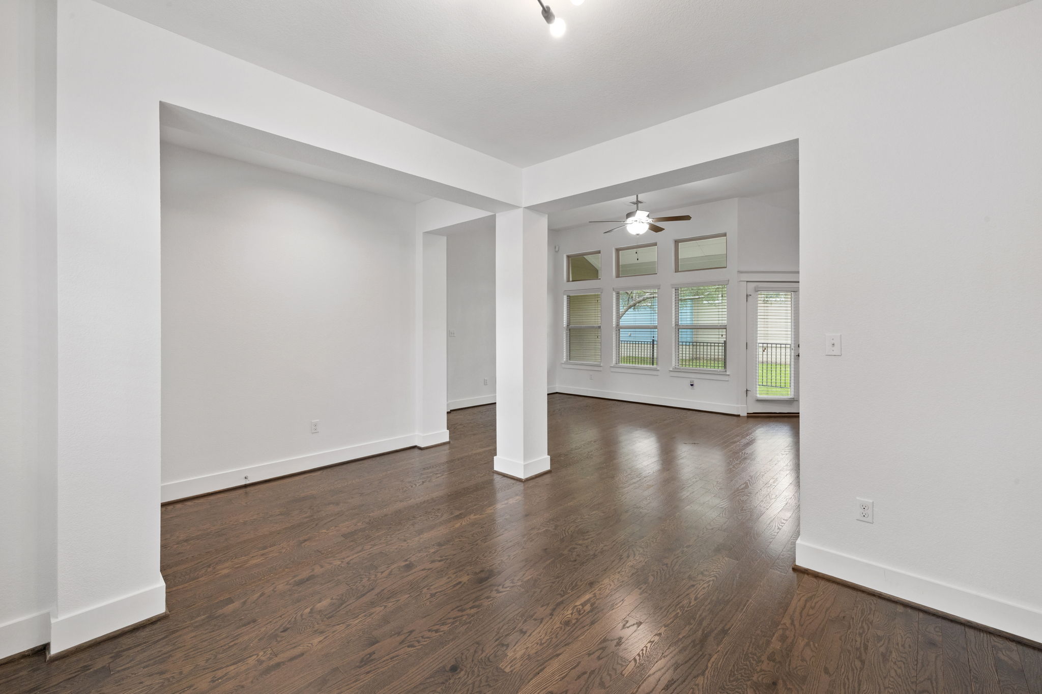 1765 Rowdy Loop, Unit 47 Leander, TX 78641 - Photo 9 of 39 Expansive living area featuring rich wood-finish flooring, crisp white walls, and high ceilings