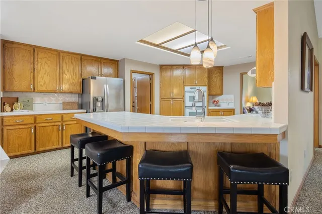 a view of an empty room with workspace and a window