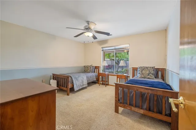 a spacious bedroom with a bed and a chandelier