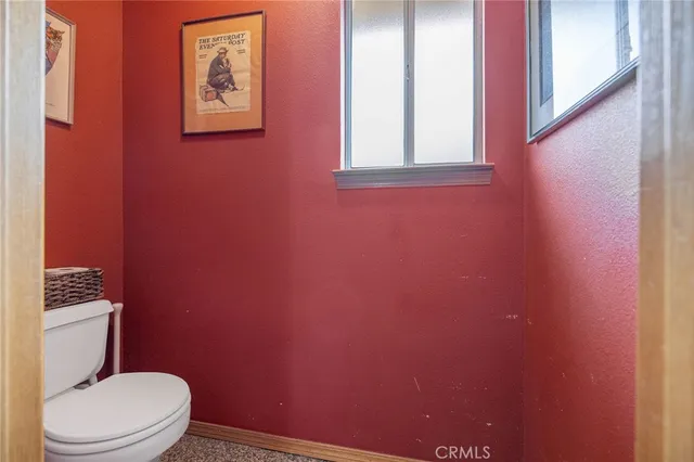 a view of a backyard with table and chairs under an umbrella