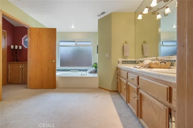 a view of a swimming pool with a table and chairs under an umbrella