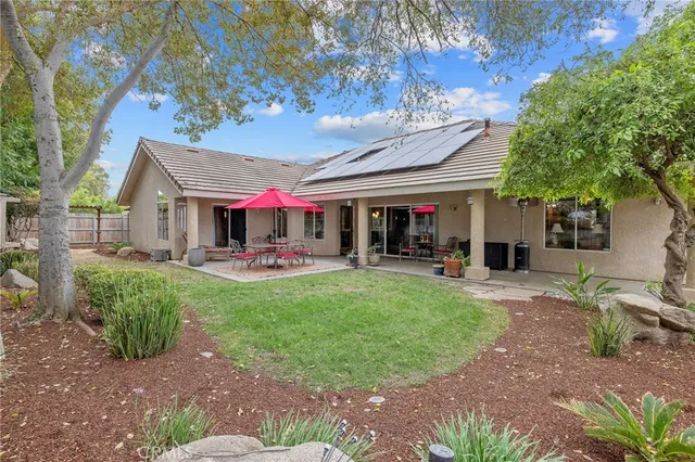 a patio with a table and chairs under an umbrella