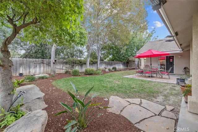 a view of a house with a yard patio and fire pit