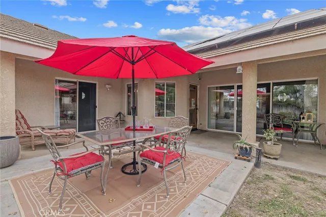 a view of a patio with a table and chairs