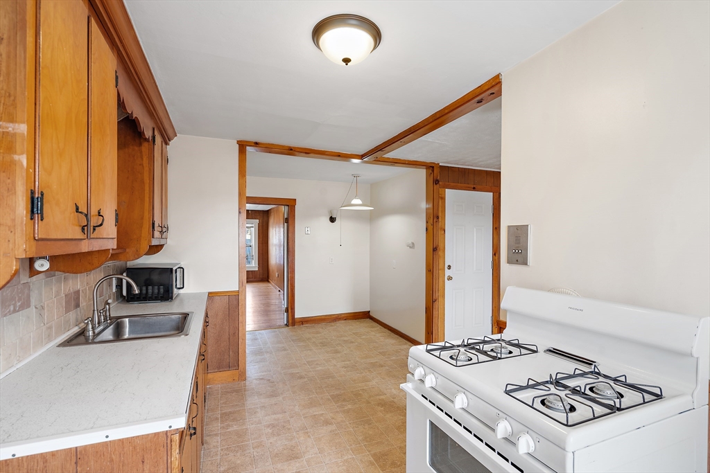 2 Sutherland Street, Unit 3 Lowell, MA 01850 - Photo 10 of 10 a kitchen that has a stove and a microwave
