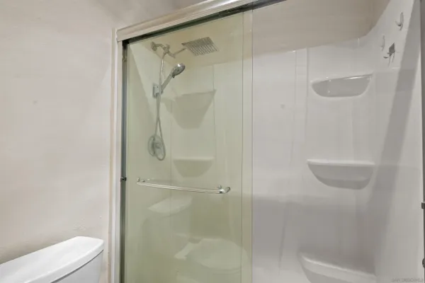a bathroom with a shower and toilet
