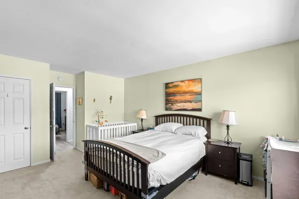 a bedroom with a bed and a tv on the dresser