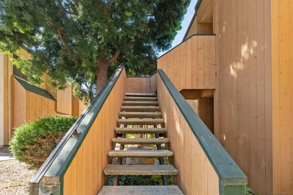 a view of balcony with wooden floor and fence