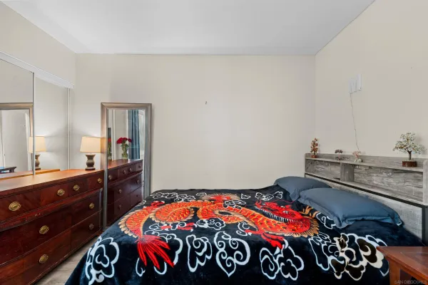 a bedroom with a bed and a dresser in it