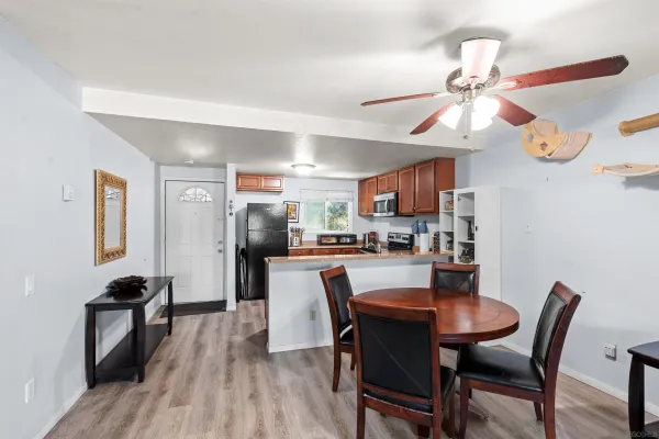 a dining room with furniture and wooden floor