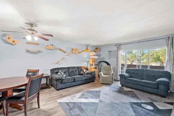 a living room with furniture a chandelier and a window